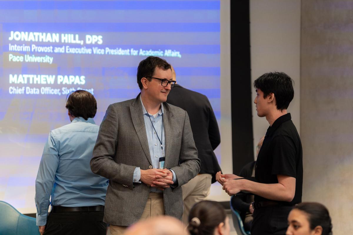 Matthew Papas, Chief Data Officer at Sixth Street, speaks with a student during the Pace of Fintech Conference.