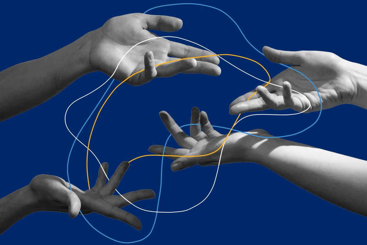 Black and white image of hands gesticulating with ribbons of blue and gold woven around them.