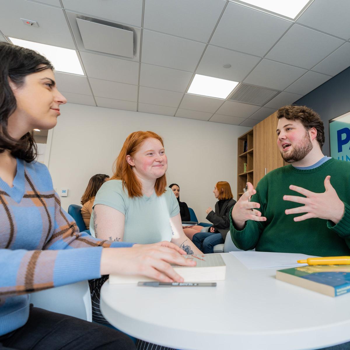 Pace University Publishing students talking together at a table