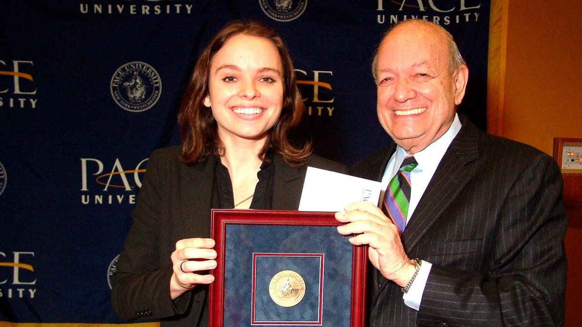 Kelly Herbert '06 accepting the President's Extra Mile Award from then-Pace President Stephen J. Friedman; 2011.