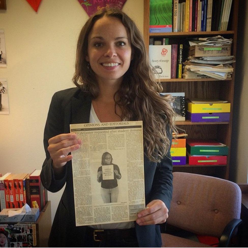 Kelly Herbert '06 holding an article she wrote advocating for the Center for the Pace Press; August 2015.