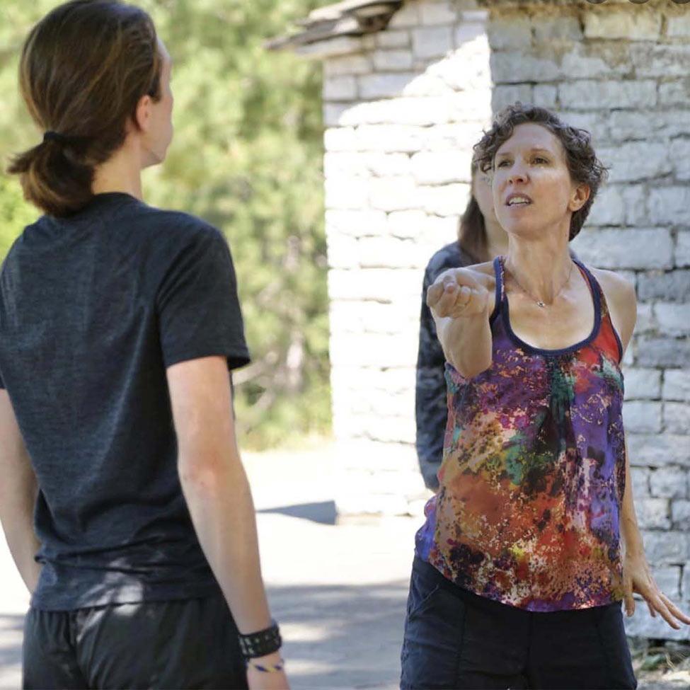 Pace University faculty member Adrienne Kapstein works with students during a devised theater piece