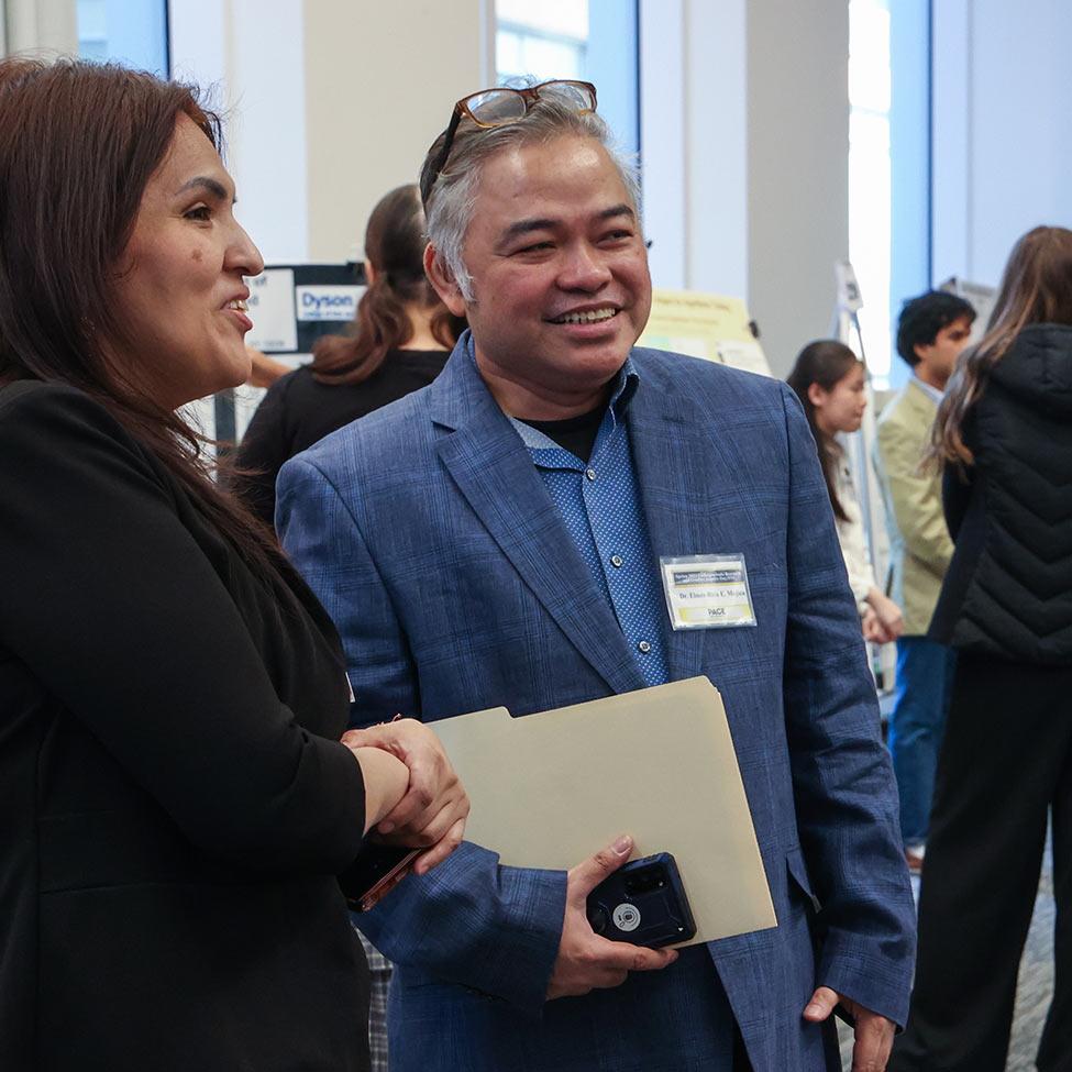 Pace professor Elmer-Rico Mojica smiles at a research event