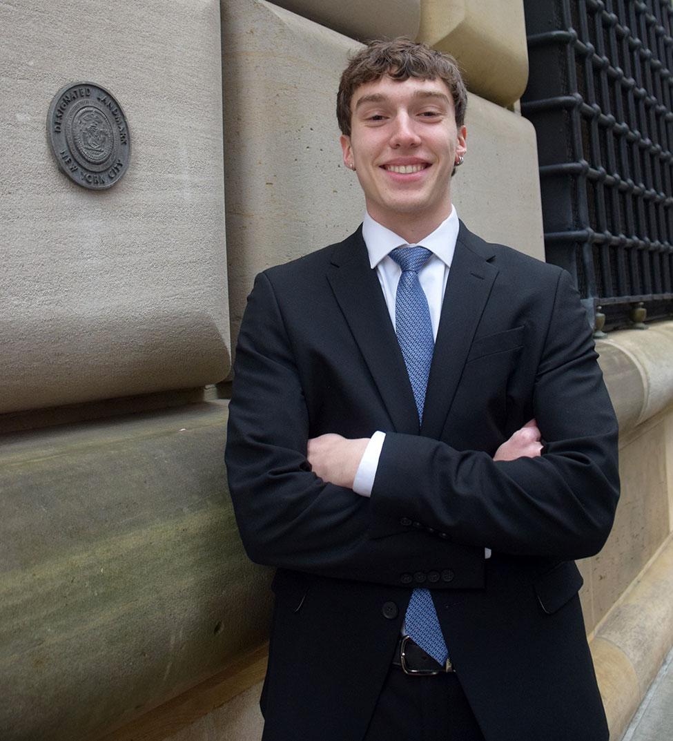Pace University Federal Reserve Challenge Team member Alexander Tuosto '26 standing in front of the Federal Reserve Bank