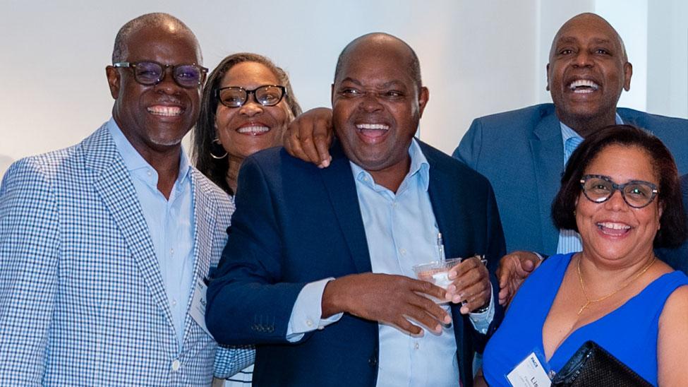 Joseph Benfield ’91 posing with a group of Pace alumni.