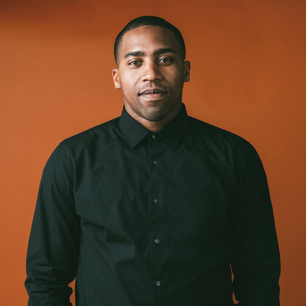 Google AI Lead Craig King pictured in front of an orange background