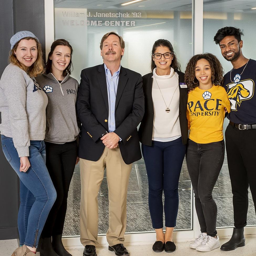 Bill Janetschek '92 posing with members of the Pace Community.