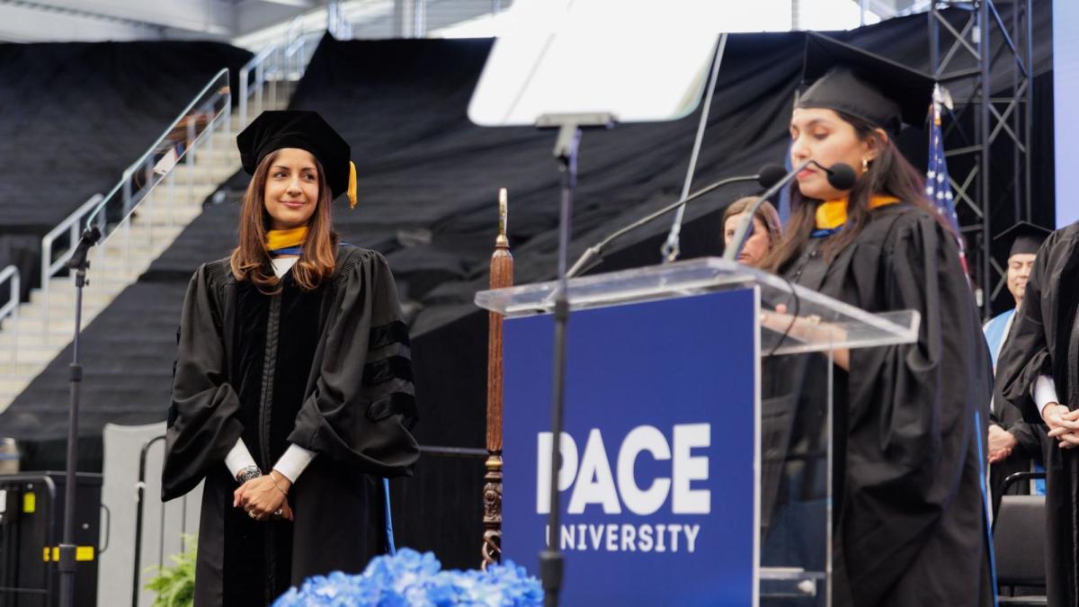 Pace Seidenberg alum Lolita Tiwari speaking on stage at the 2025 Pace Commencement to honor her mentor and honorary PhD recipient, Anjali Sud.