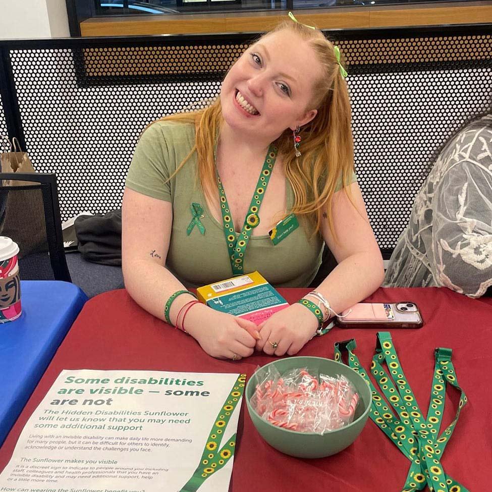 Pace University student, Lucie Flagg wearing her sunflower lanyard