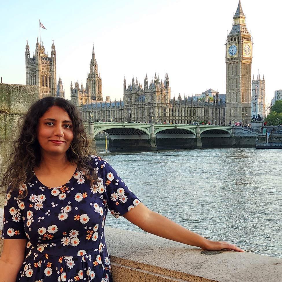Female Publishing program alum from Pace University, Sabeen Aziz, standing near water