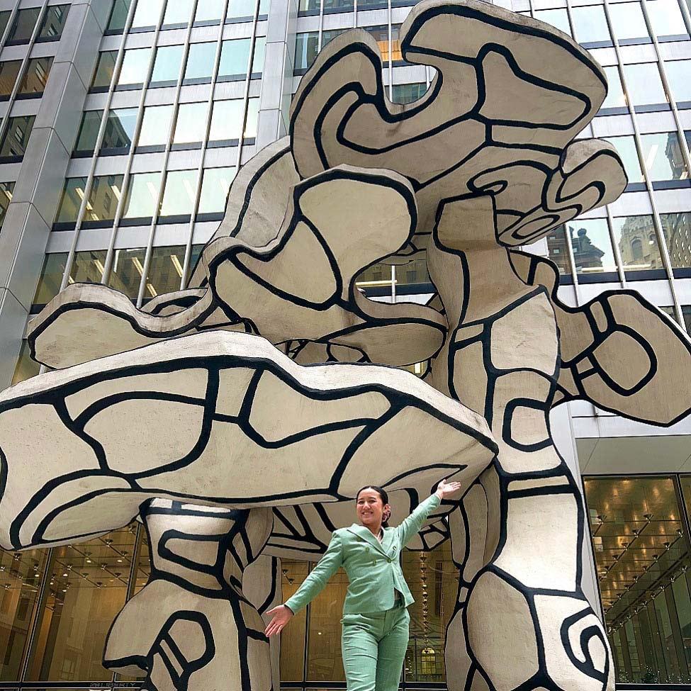 Elisabeth Haub School of Law student ThuLan Pham standing in front of a sculpture in NYC