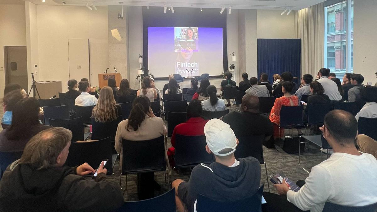 Audience attending fintech presentation in lecture hall