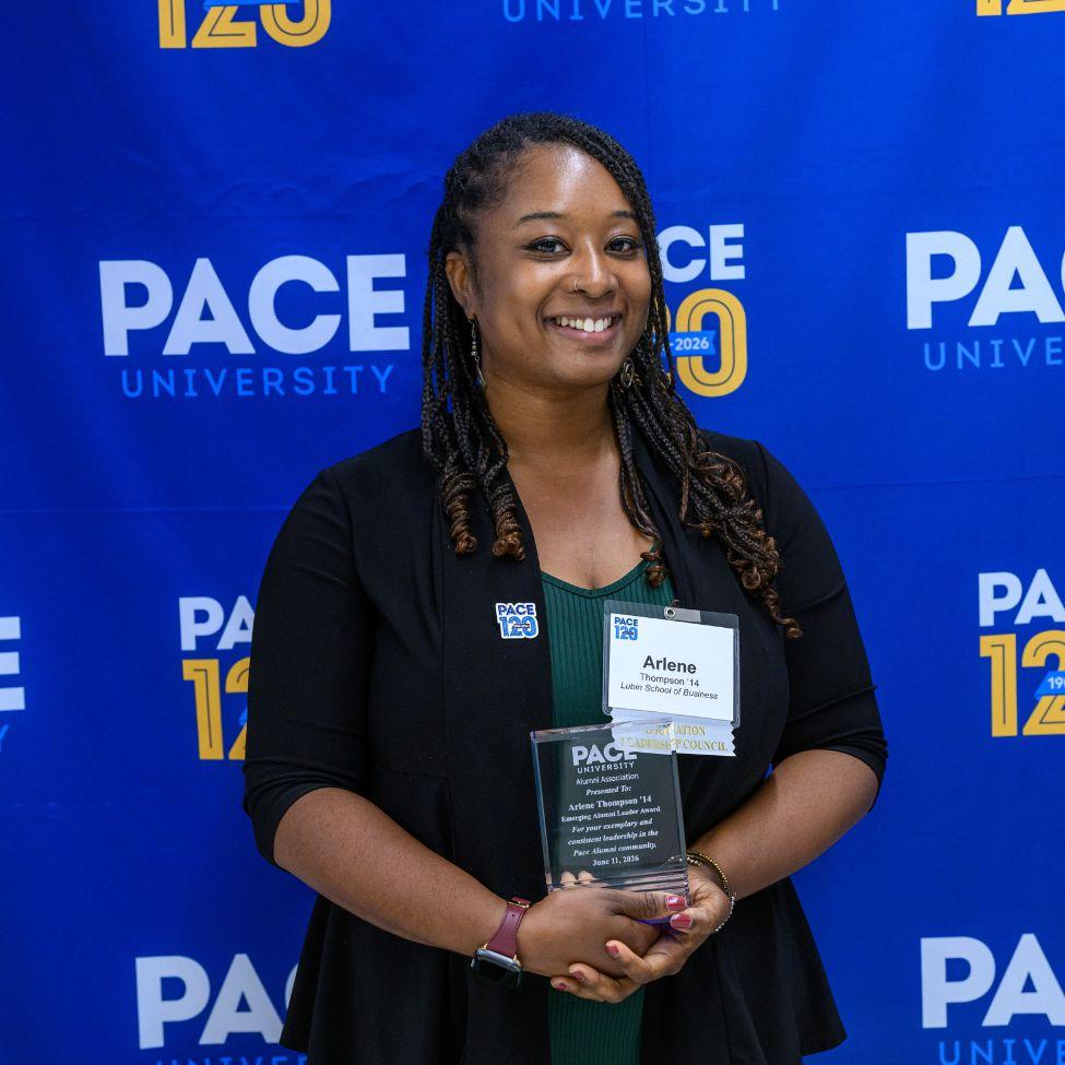 Arlene Thompson '14 holding the Emerging Alumni Leader Award.