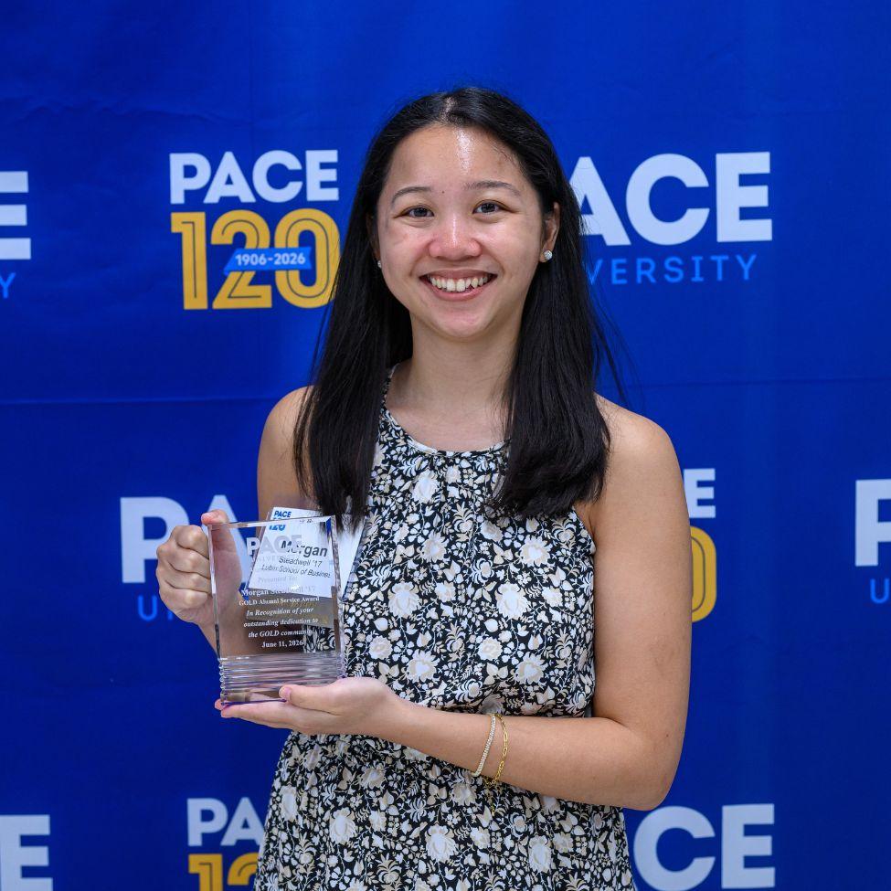 Morgan Steadwell '17 holding the GOLD Alumni Service Award.