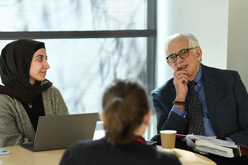 Elisabeth Haub school of Law professor Michael Mushin speaks with students
