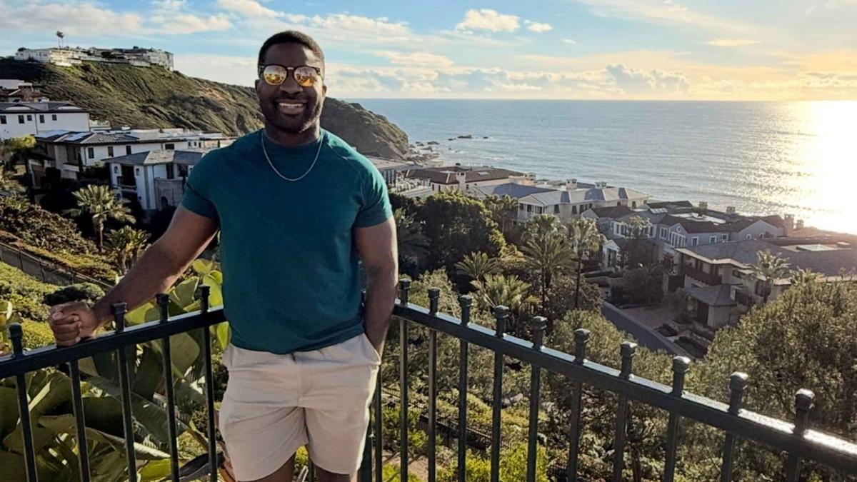 Onye Ohiaeri, Seidenberg alum, standing by a rocky shoreline