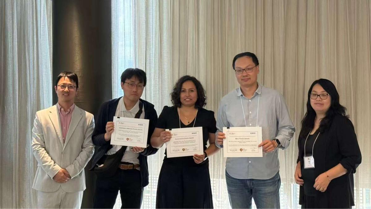 Dr. Zhan Zhang with fellow winners holding a Best Paper Award