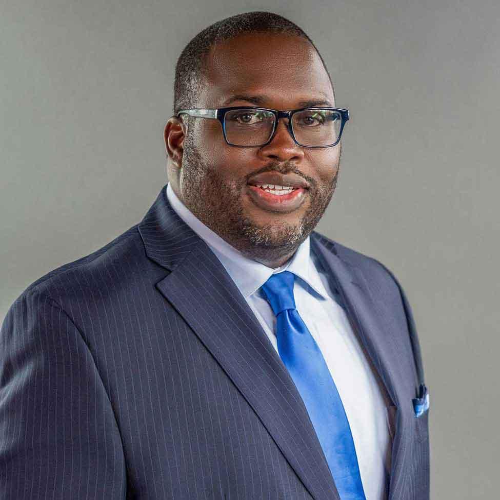 Vincent Clark wears a blue suit with a blue tie