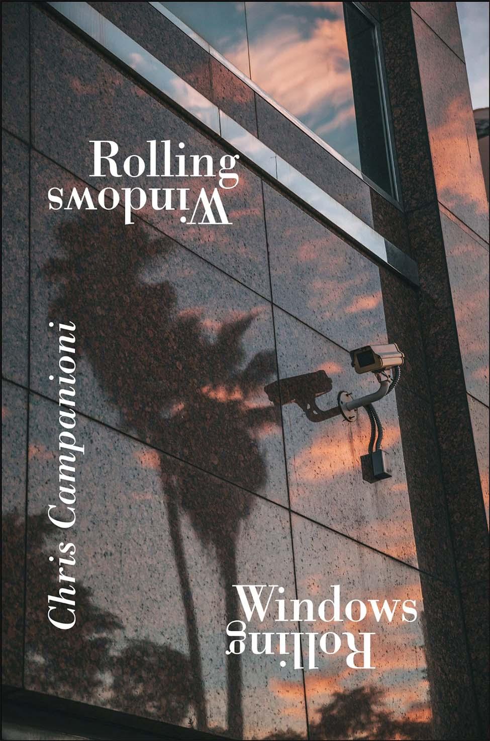 Cover of Chris Campanioni's latest publication, Rolling Windows. The title and author's name are printed in white text over a reflective side of an wall of windows with a security camera. 