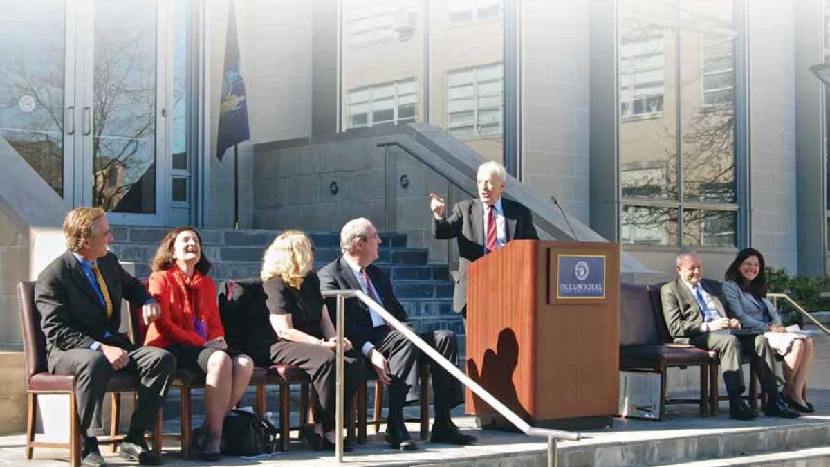 Dean Emeritus Richard Ottinger speaking in front of Ottinger Hall