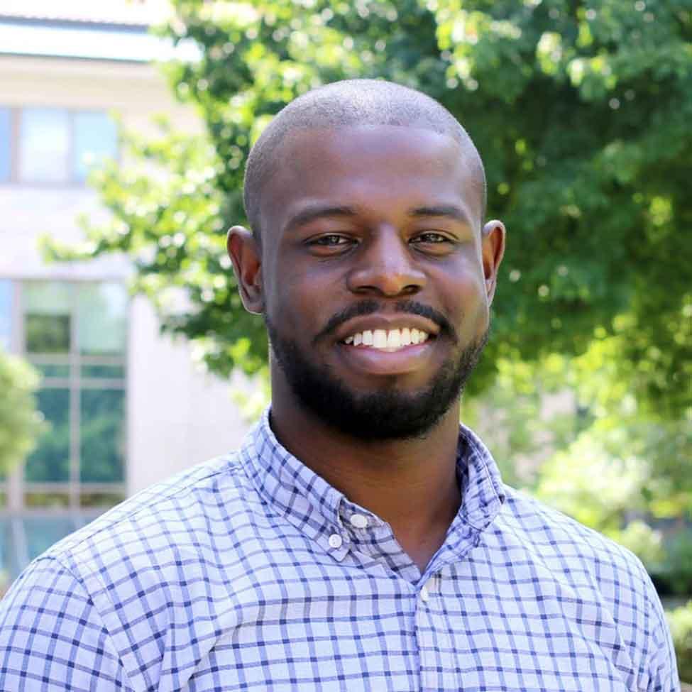 Michael Toney, a senior program manager at Google Research, wears a blue shirt and stands outside