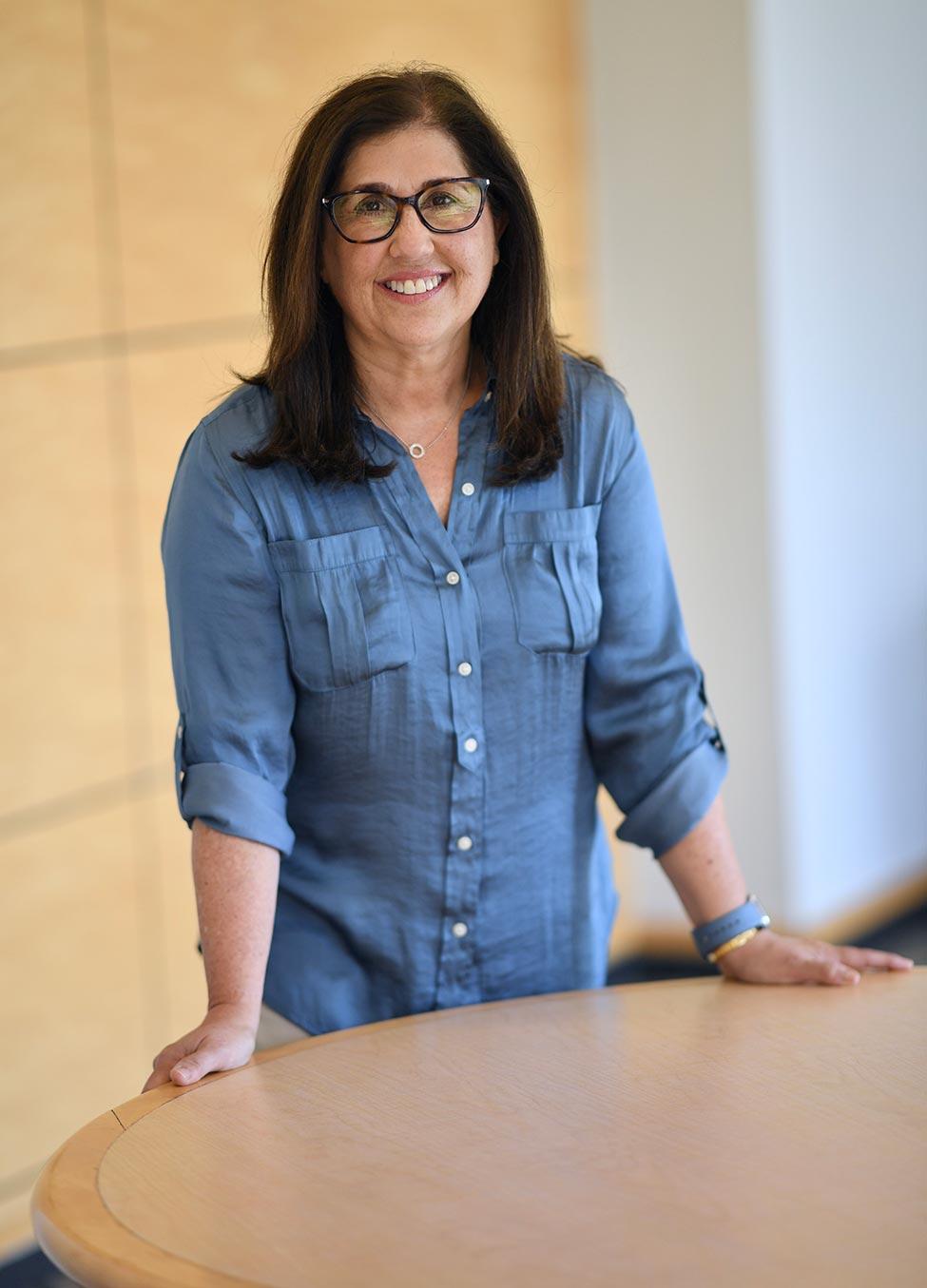 Cindy Kanusher in a denim shirt posing for the camera.