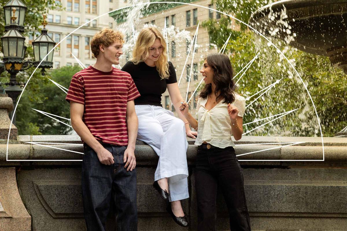 Group of Pace University students sitting by a fountain in NYC.