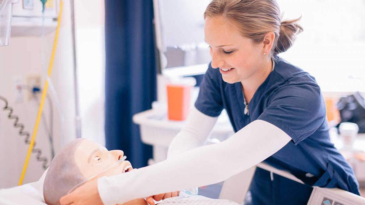 Student nurse working on a dummy.