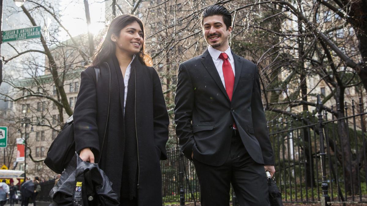 Students in business attire walking around NYC.