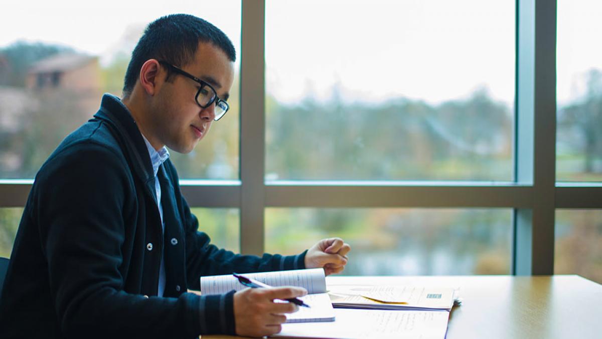 Student writing a paper.