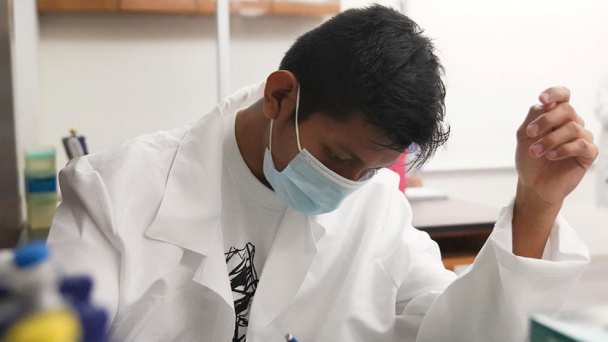 Student doing lab work during a Biology class.