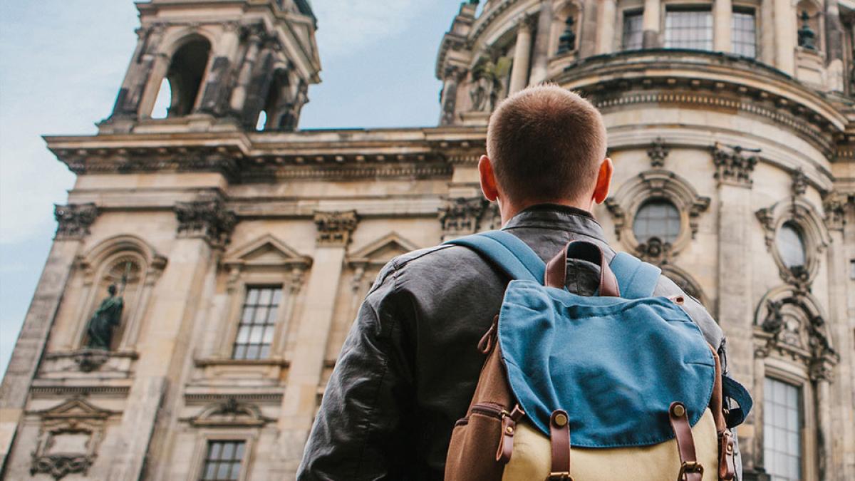 Student admiring a building on his study abroad trip.