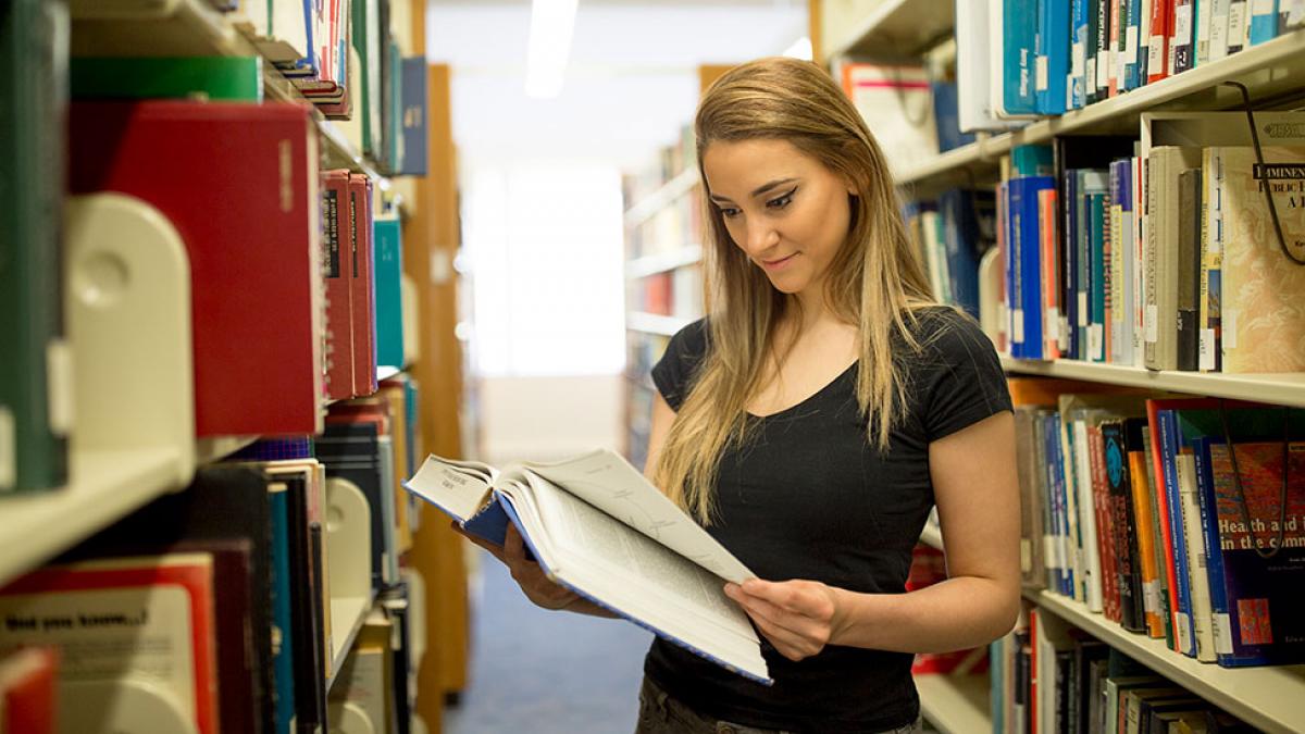 Student reading books in the library.