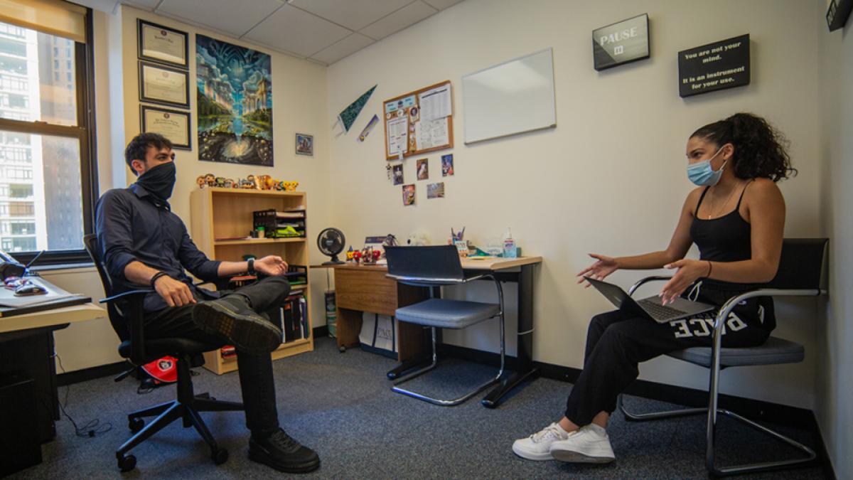 Student sitting with an adviser.