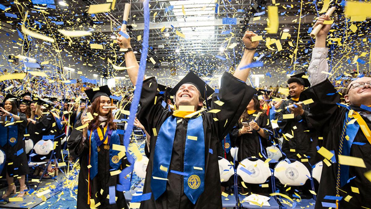 Male students celebrating his graduation.