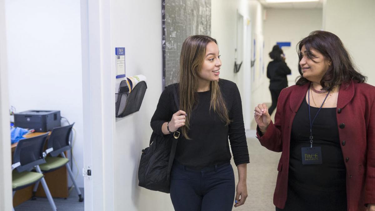 Student walking with a counselor.