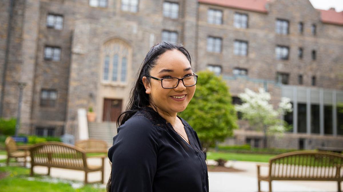 Student smiling at the camera on the Law campus.