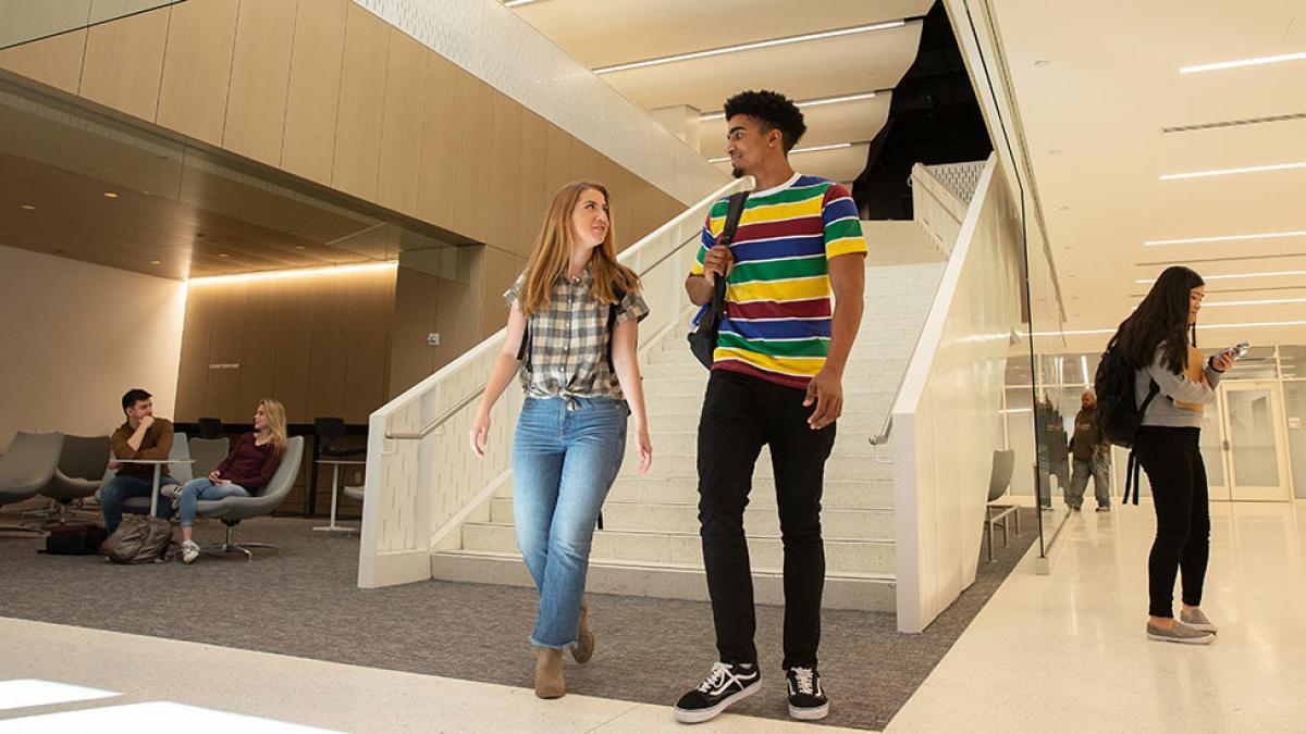 Students walking and talking inside of One Pace Plaza in NYC.