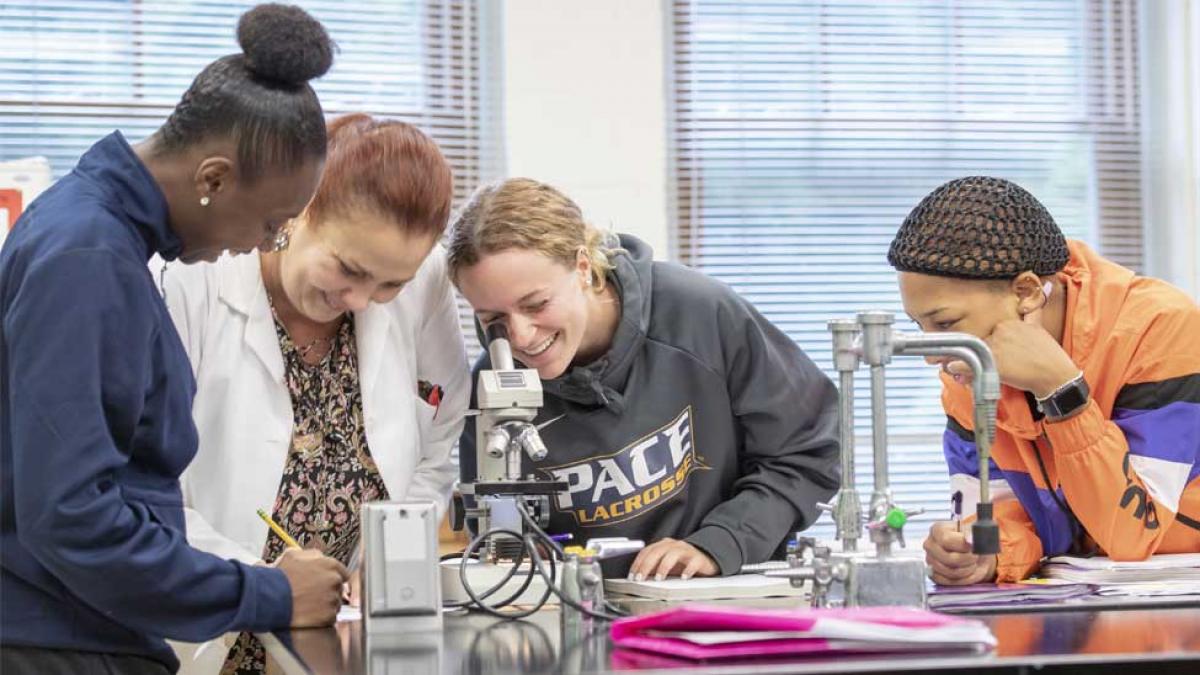Pace students using a microscope
