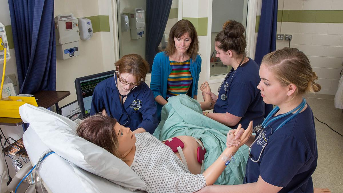 College of Health Professions students working with a faculty member in the simulation lab.