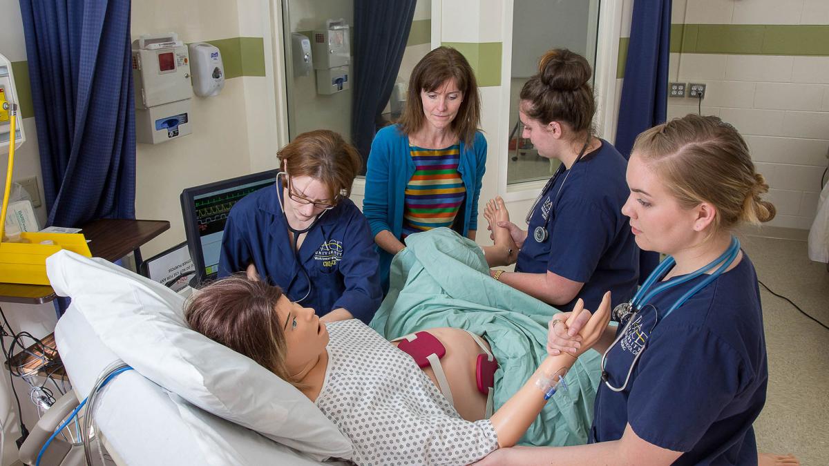 College of Health Professions students working with a faculty member in the simulation lab.