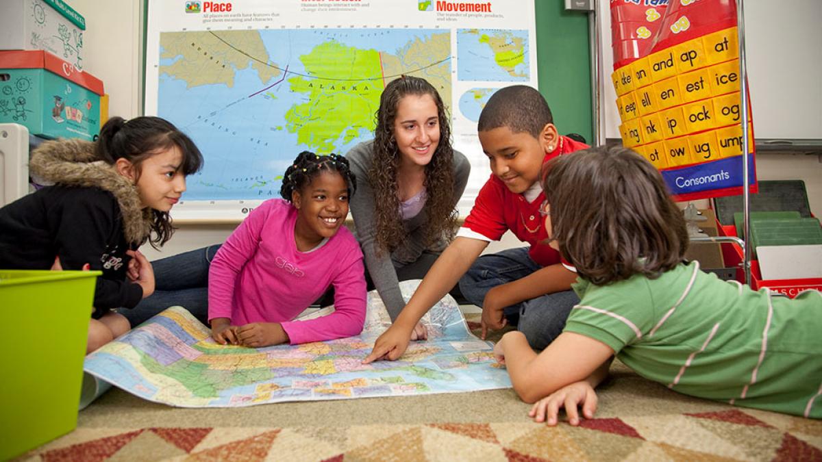 School of Education student working in a classroom setting with young children.