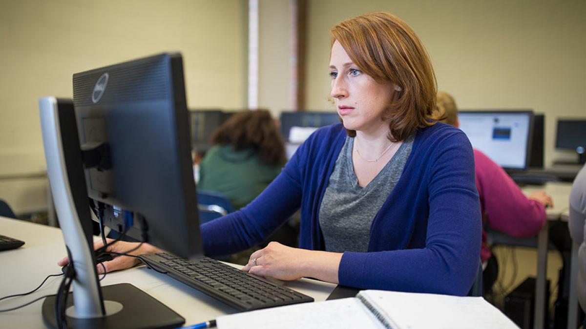 School of Education student taking classes on her computer.