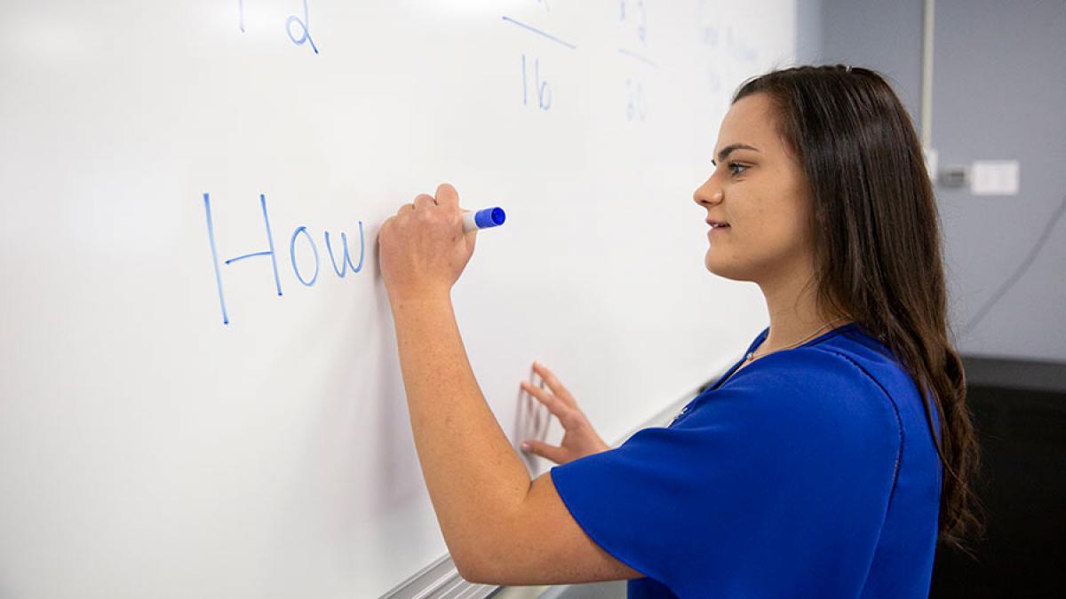 Student writing on the board.