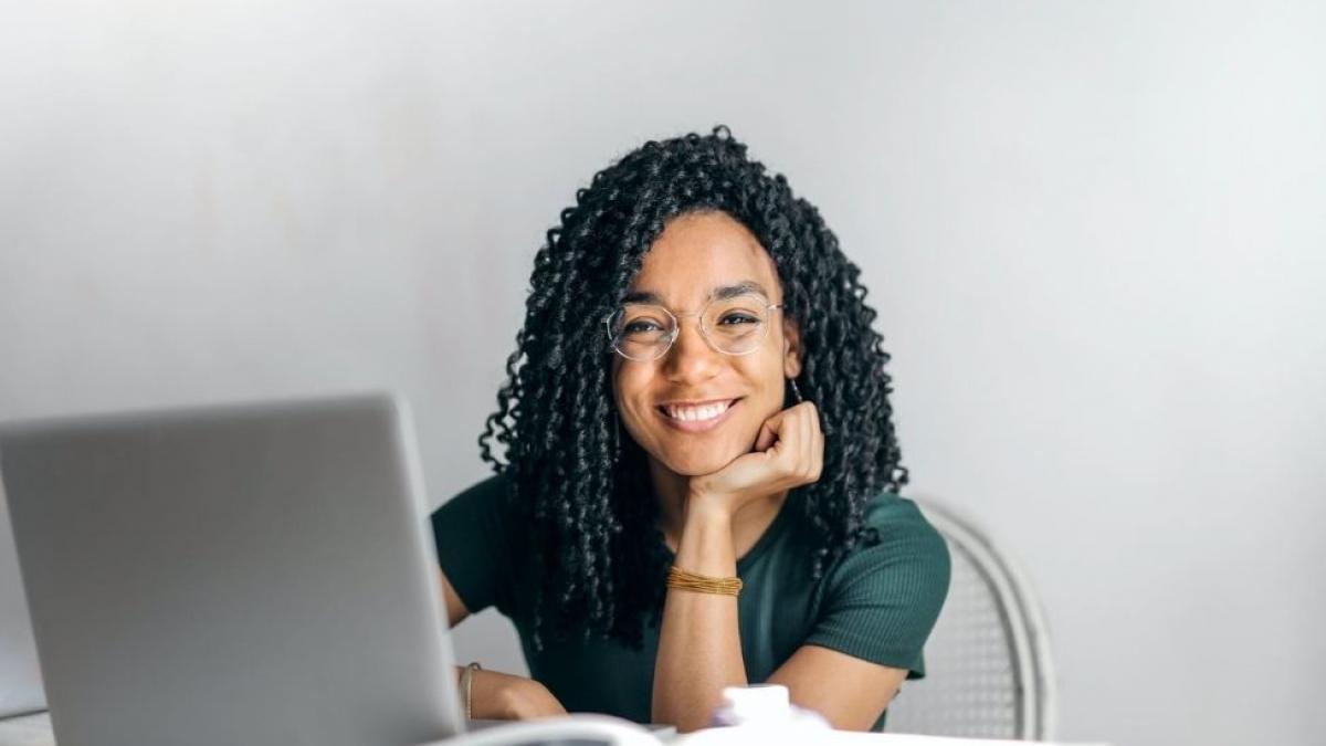 Female student smiling on laptop