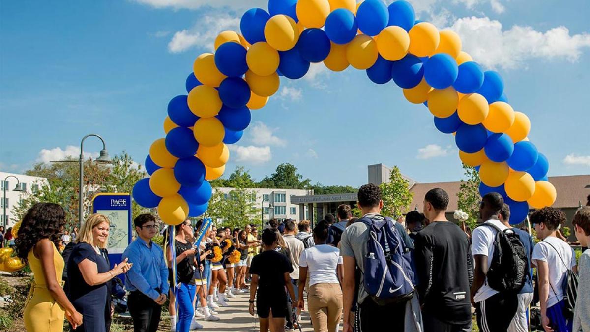 balloon arch and groups of students