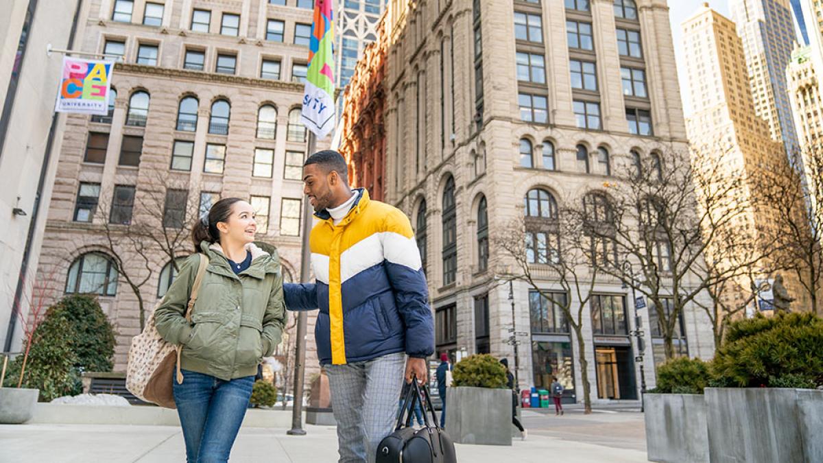 Two pace students in front of the 41 Park Row building