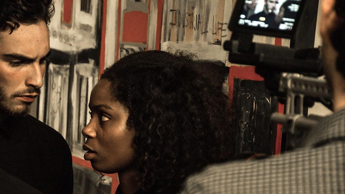 Two actors infront of viewfinder of a camera