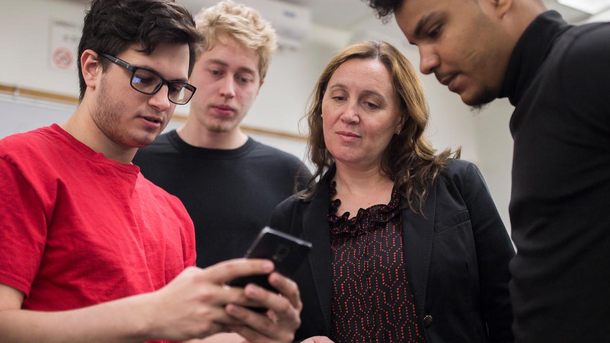 Seidenberg Professor Christelle Scharff working with students on a project. 