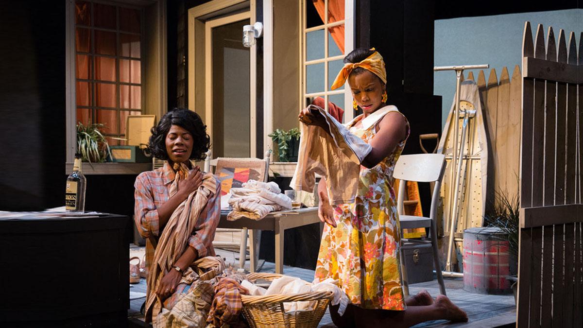 Two african american female actors performing on stage